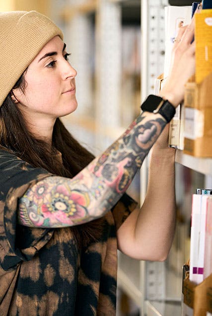 Woman pulling a book off the shelf